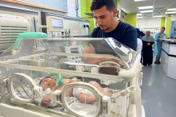 Ayman Abu Shamalah stands next to his daughter Mecca as she receives care inside an incubator at a hospital in Rafah on October 23, 2023. An Israeli strike killed his children and his wife, Dareen Abu Shamalah.<span class="copyright">Mai Yaghi—AFP/Getty Images</span>