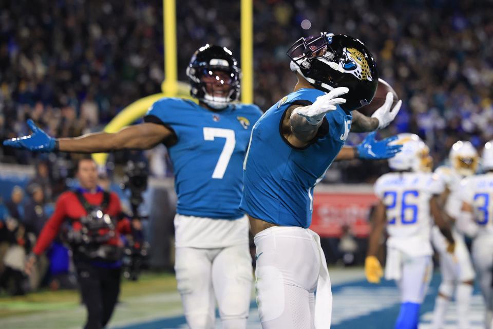 Jacksonville Jaguars wide receiver Marvin Jones Jr. (11) celebrates his touchdown reception score as wide receiver Zay Jones (7) greets him in the end zone during the third quarter of an NFL first round playoff football matchup Saturday, Jan. 14, 2023 at TIAA Bank Field in Jacksonville, Fla. Jacksonville Jaguars edged the Los Angeles Chargers on a field goal 31-30. [Corey Perrine/Florida Times-Union]