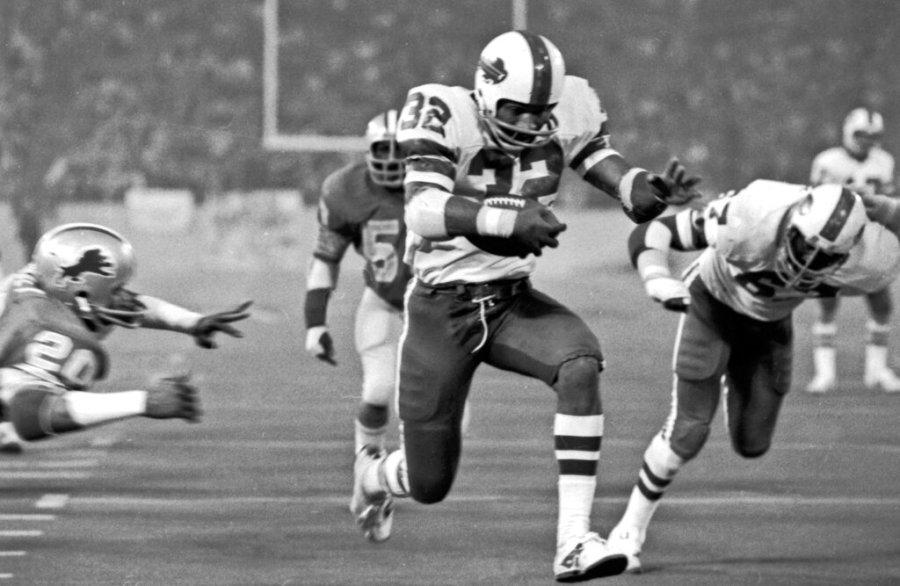 In this Nov. 25, 1976 file photo, Buffalo Bills’ O.J. Simpson rushes through a large hole in the center fo the Detroit Lions defensive line to score on a 12-yard run for his second touchdown of the game in an NFL football game in Pontiac, Mich. Simpson added some “Juice” – rushing for a Thanksgiving Day-record 273 yards – to what wound up as a 27-14 Bills defeat at the hands of the Lions at the Pontiac Silverdome on Thanksgiving Day 1976. (AP Photo/File)