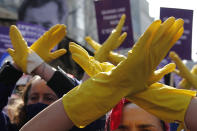 FILE - In this March 8, 2021 file photo, women react during a march to mark International Women's Day, in Paris. Despite recent French training programs for police and growing awareness around violence against women, activists say authorities must do more to face up to the gravity of sex crimes, and to eradicate discrimination against victims. (AP Photo/Francois Mori, File)