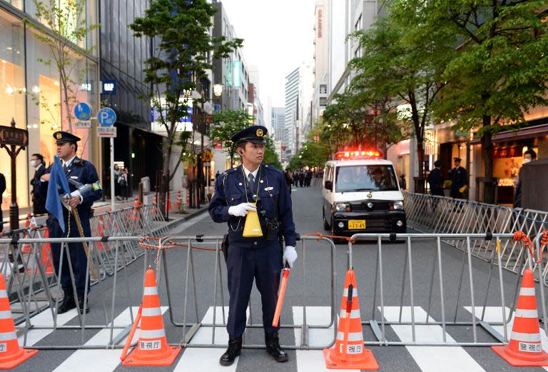 Police officers in the Ginza shopping district in Tokyo on April 23, 2014