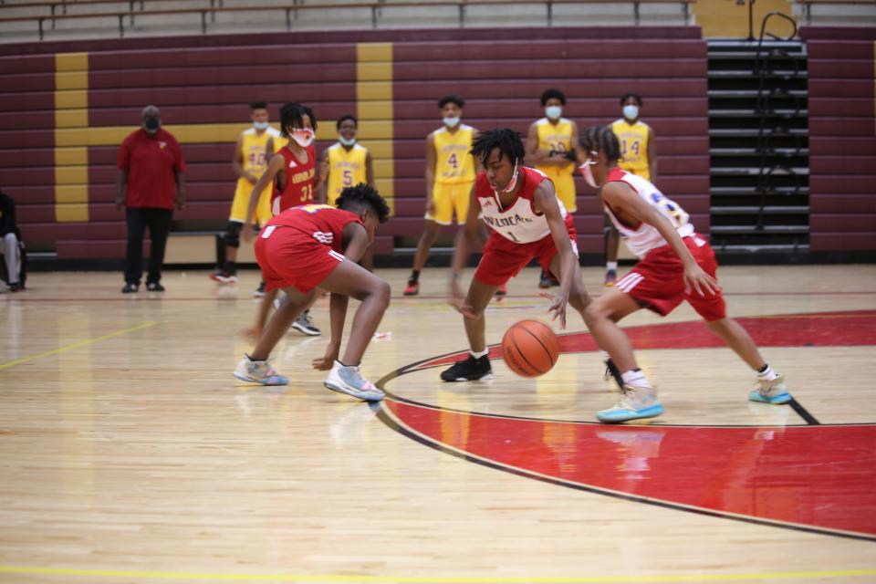 Varsity looks on as the middle schoolers scrimmage in front of their parents.