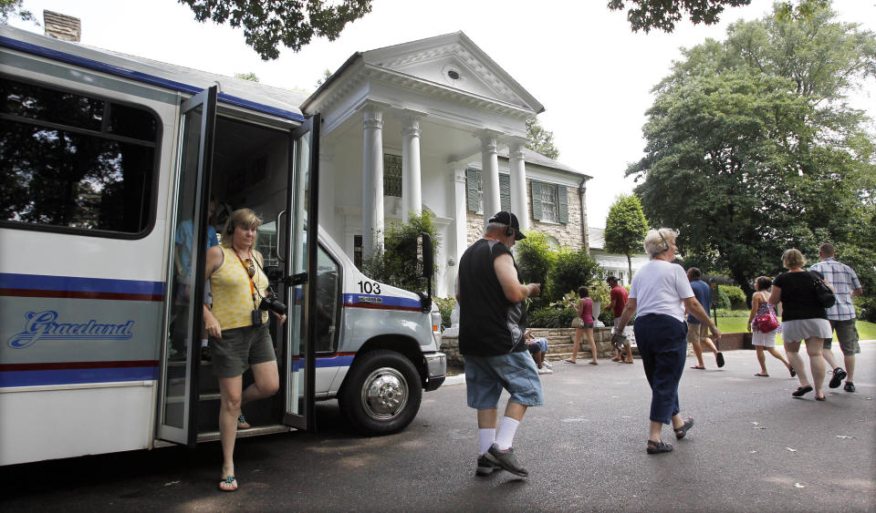 FILE -- This Aug. 2010 photo shows tourists arriving at Graceland, Elvis Presley's home in Memphis, Tenn. Graceland opened for tours on June 7, 1982. They sold out all 3,024 tickets on the first day and didn't look back, forever changing the Memphis tourist landscape while keeping Elvis and his legend alive.(AP Photo/Mark Humphrey)