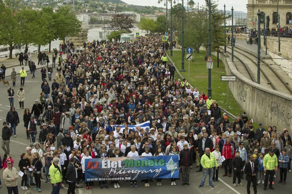 Participants of the March of the Living, which commemorates the victims of the Holocaust, walk along the Pest embankment of the River Danube in downtown Budapest, Hungary, Sunday, Apr. 16, 2017. The annual event marks the 73rd anniversary of the beginning of the Hungarian holocaust, during which some 600 thousand Jewish Hungarians were deported to Nazi death camps. (Bea Kallos/MTI via AP)