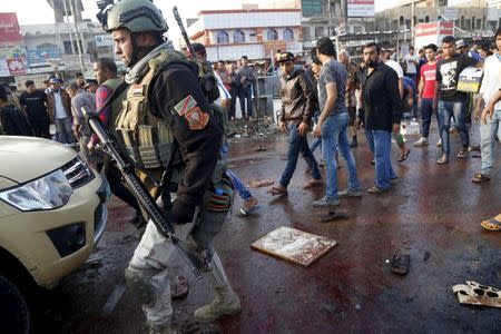 A soldier walks at the site of suicide blasts in Baghdad's Sadr City Iraq February 28, 2016. REUTERS/Wissm al-Okili