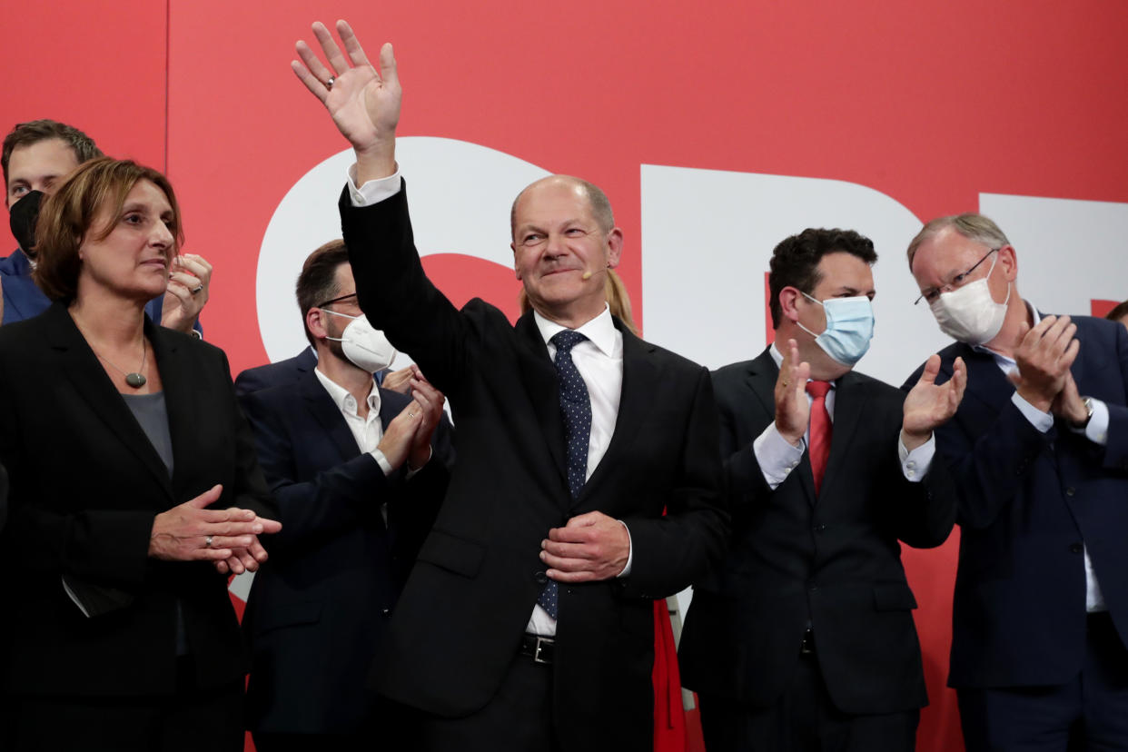 Olaf Scholz, top candidate for chancellor of the Social Democratic Party (SPD) waves to his supporters after German parliament election at the party's headquarters in Berlin, Sunday, Sept. 26, 2021. (AP Photo/Lisa Leutner)