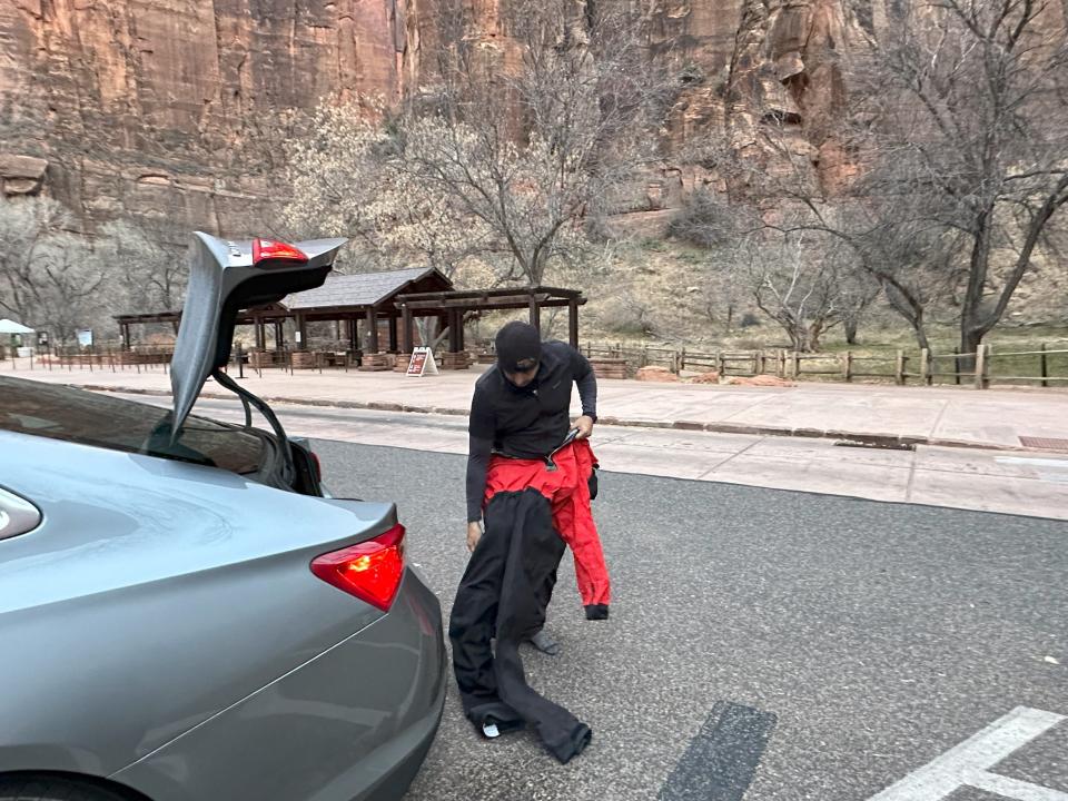 Author Amanda Adlergetting into a waterproof suit at Zion national park