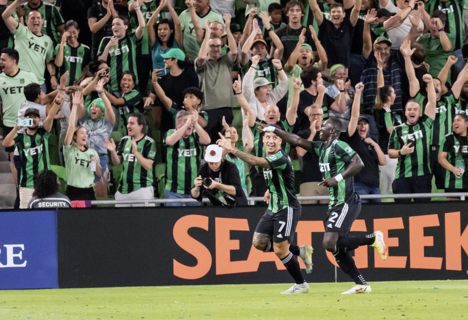 Austin FC forward Moussa Djitte (2) celebrates his goal with teammate Sebastian Driussi (7) during the first half an MLS playoff soccer match against FC Dallas, Sunday, Oct. 23, 2022, in Austin, Texas. (AP Photo/Michael Thomas)