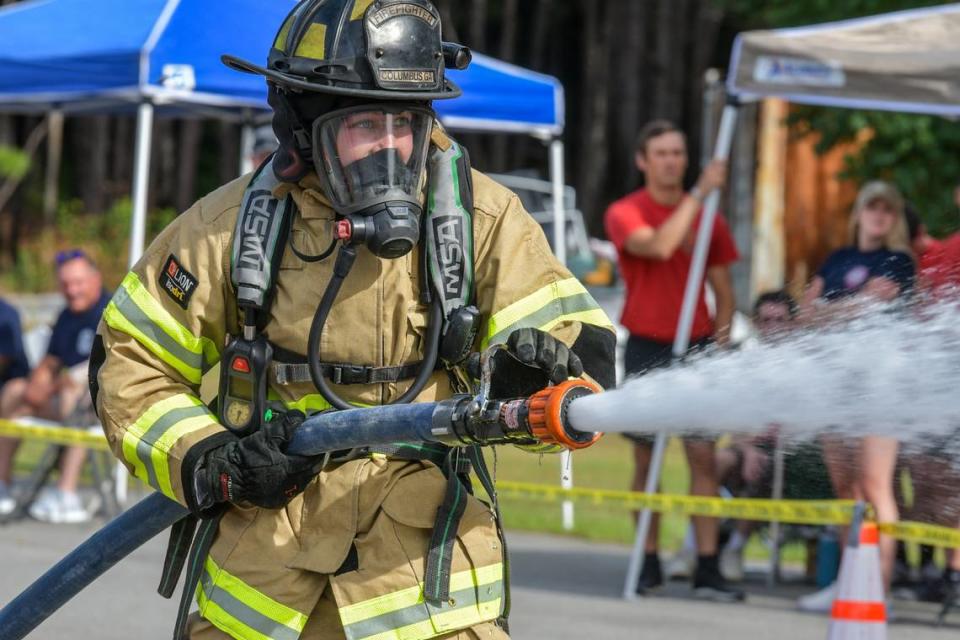 Claire Droppleman, aims and hits the target with the firehose on the course of the 40th anniversary of the Columbus Police and Fire, Wednesday morning, June 19, 2024.