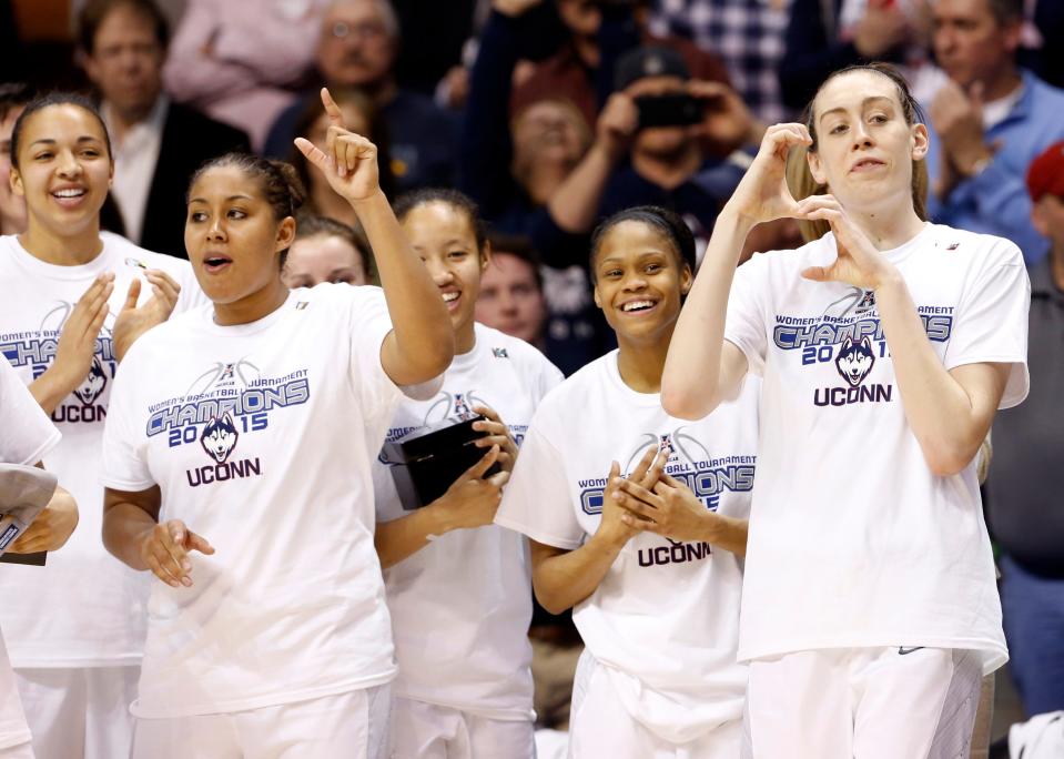 Connecticut forward Breanna Stewart (30) and forward Kaleena Mosqueda-Lewis (left) react as forward Morgan Tuck (not pictured) is called to receive her team watch after the Huskies defeated South Florida during the final round of the American Conference Tournament in 2015.