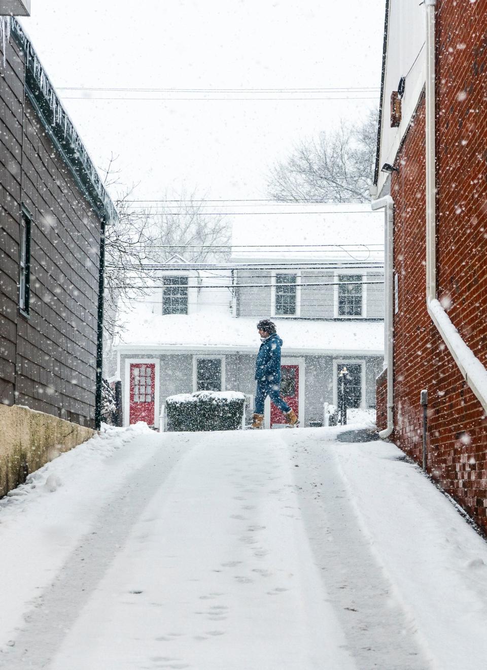 A person walks along Main Street as snow continues to fall in Yardley on Friday, Jan. 19, 2024.

Daniella Heminghaus | Bucks County Courier Times