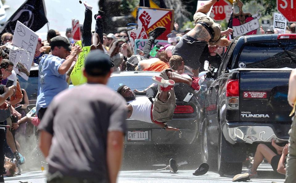 People fly into the air as a vehicle drives into a group of protesters in Charlottesville on&nbsp;Aug. 12, 2017. (Photo: Ryan M. Kelly/The Daily Progress via AP)