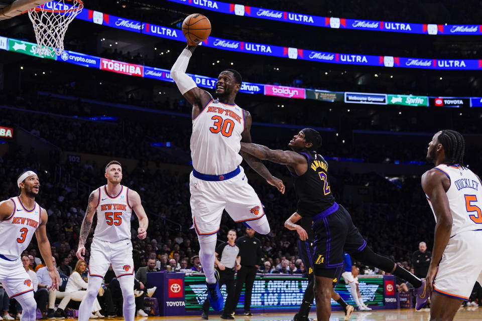 New York Knicks forward Julius Randle (30) jumps for a rebound against Los Angeles Lakers forward Jarred Vanderbilt (2) during the first half of an NBA basketball game, Monday, Dec. 18, 2023, in Los Angeles. (AP Photo/Ryan Sun)