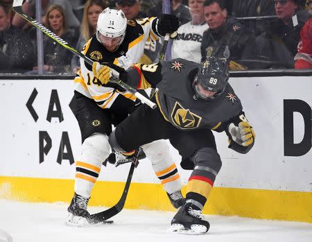 Feb 20, 2019; Las Vegas, NV, USA; Boston Bruins right wing Chris Wagner (14) battles Vegas Golden Knights right wing Alex Tuch (89) during the third period at T-Mobile Arena. Mandatory Credit: Stephen R. Sylvanie-USA TODAY Sports