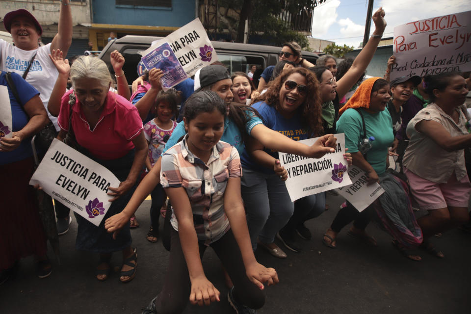 Women and girls celebrate outside court where Evelyn Hernandez was acquitted on charges of aggravated homicide in her retrial related to the loss of a pregnancy in 2016, in Ciudad Delgado on the outskirts of San Salvador, El Salvador, Monday, Aug. 19, 2019. Hernandez, who has said she did not realize she was pregnant as the result of a rape when she gave birth into a latrine at 32 weeks, was originally sentenced to 30 years under El Salvador's strict abortion laws. (AP Photo/Salvador Melendez)