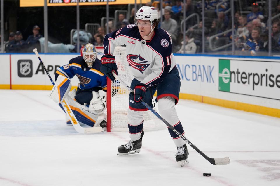 Columbus Blue Jackets' Dmitri Voronkov (10) looks to pass as St. Louis Blues goaltender Jordan Binnington (50) watches during the first period of an NHL hockey game Tuesday, Jan. 30, 2024, in St. Louis. (AP Photo/Jeff Roberson)