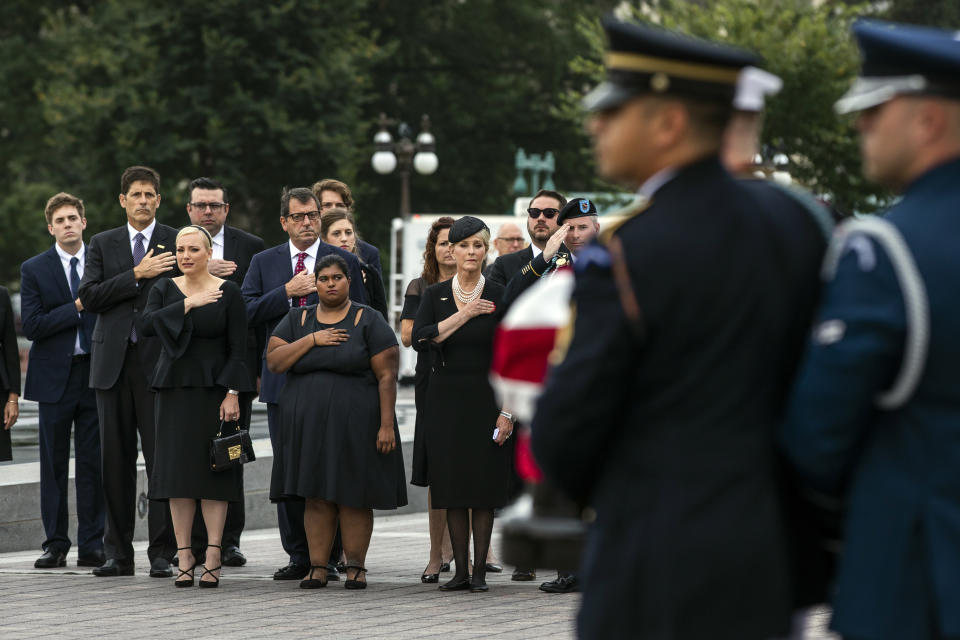 The family of Sen. John McCain, R-Ariz., front row from left, Meghan McCain, Bridget McCain and Cindy McCain, watches as his casket is carried to a hearse from the U.S. Capitol in Washington, Saturday, Sept. 1, 2018, in Washington, for a departure to the Washington National Cathedral for a memorial service. (Jim Lo Scalzo/Pool Photo via AP)