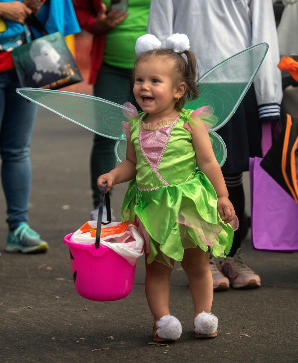 17-month-old Penelope Hicks wears a Tinkerbell costume at the Trunk or Treat event put on by San Joaquin County Parks at Micke Grove Park in Lodi on Friday, Oct. 13, 2023. 79 groups, organizations and individuals gave out candy and treats in the second year of the event. More than 2,500 people were expected to attend.