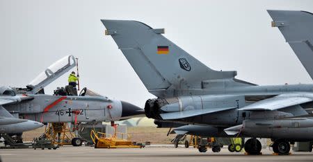 FILE PHOTO: A technician works on a German Tornado jet at the air base in Incirlik, Turkey, January 21, 2016. REUTERS/Tobias Schwarz/Pool/File Photo