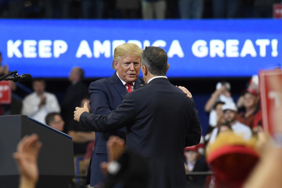 President Donald Trump, left, talks to Kentucky Gov. Matt Bevin, right, during a campaign rally in Lexington, Ky., Monday, Nov. 4, 2019. (AP Photo/Susan Walsh)