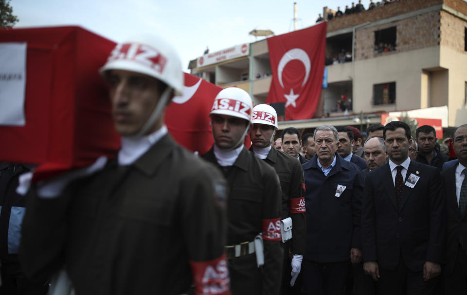 Turkey's Defence Minister Hulusi Akar, third right, attends a funeral ceremony for Halil Ibrahim Akkaya, one of Turkish soldiers killed in Syria, in Bahce, Osmaniye, Turkey, Turkey, Friday, Feb. 28, 2020. NATO envoys were holding emergency talks Friday at the request of Turkey following the killing of 33 Turkish soldiers in northeast Syria, as scores of migrants gathered at Turkey's border with Greece seeking entry into Europe. (AP Photo)