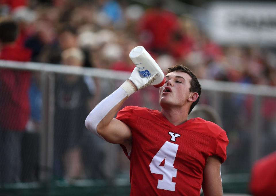 Yankton’s Tucker Gilmore takes a drink of water on the sidelines during a football game against Tea Area on Friday, September 23, 2022, in Yankton.