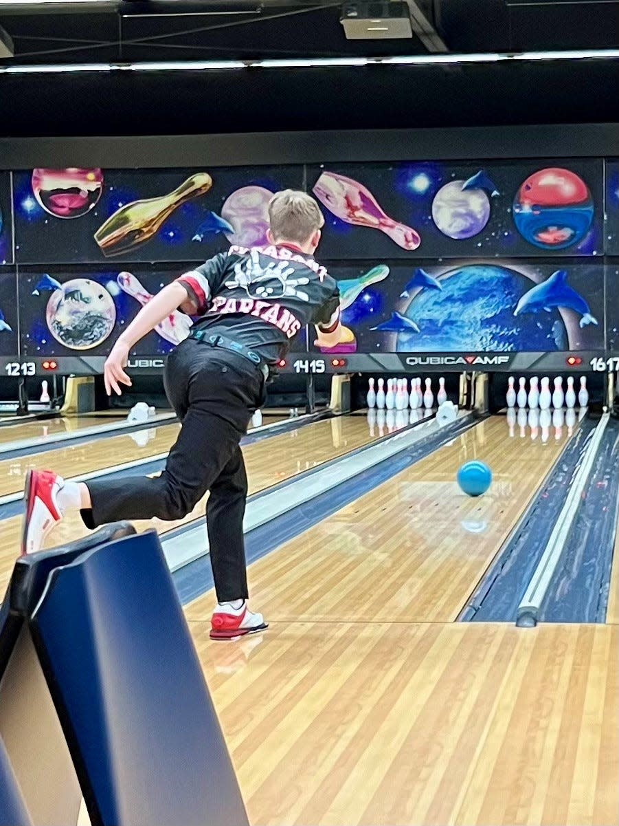 Pleasant's Nolan Ludwig takes a shot during a boys bowling match against River Valley earlier this season at Bluefusion.