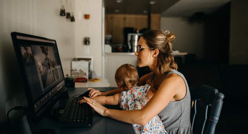 Mum working from home with daughter over working in the office.