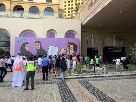 Evacuated guests return to the Movenpick hotel after a small fire broke out, in Dubai, United Arab Emirates August 7, 2017. REUTERS/Sylvia Westall