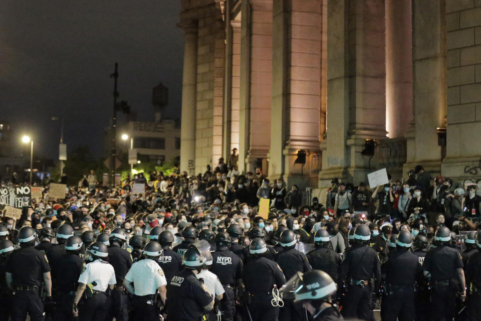 Police block protesters from exiting the Manhattan Bridge in New York, Tuesday, June 2, 2020. New York City extended an 8 p.m. curfew all week as officials struggled Tuesday to stanch destruction and growing complaints that the nation's biggest city was reeling out of control night by night. (AP Photo/Seth Wenig)