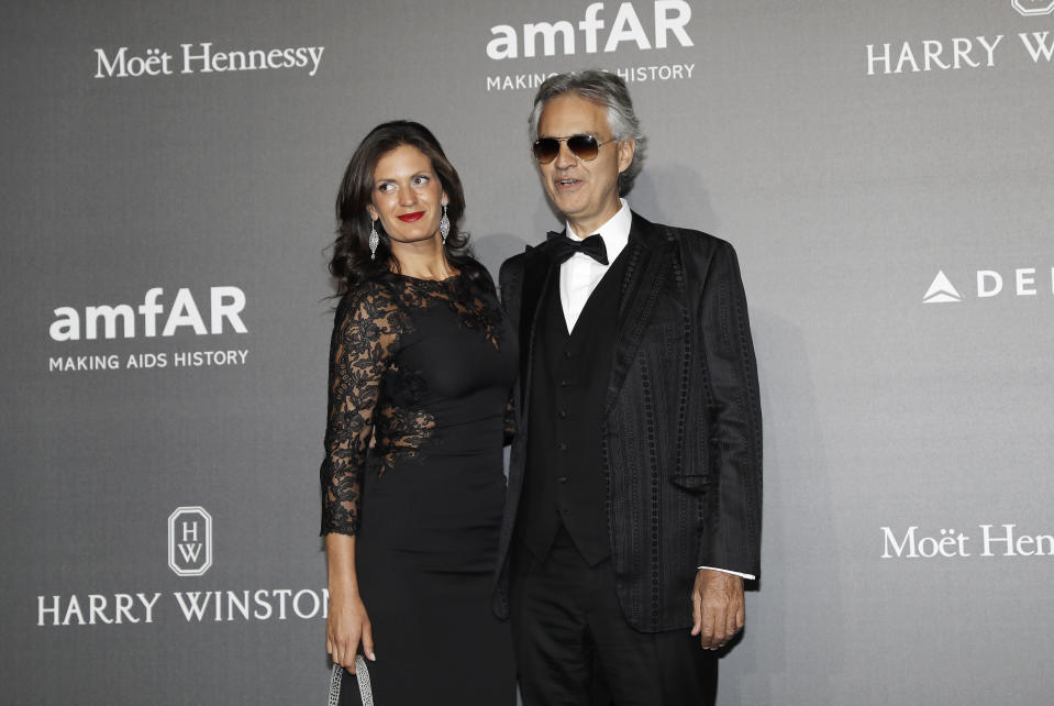 Andrea Bocelli, right, poses with his wife Veronica Berti as they arrive for the amfAR charity dinner during the fashion week in Milan, Italy, Thursday, Sept. 21, 2017. (AP Photo/Antonio Calanni)