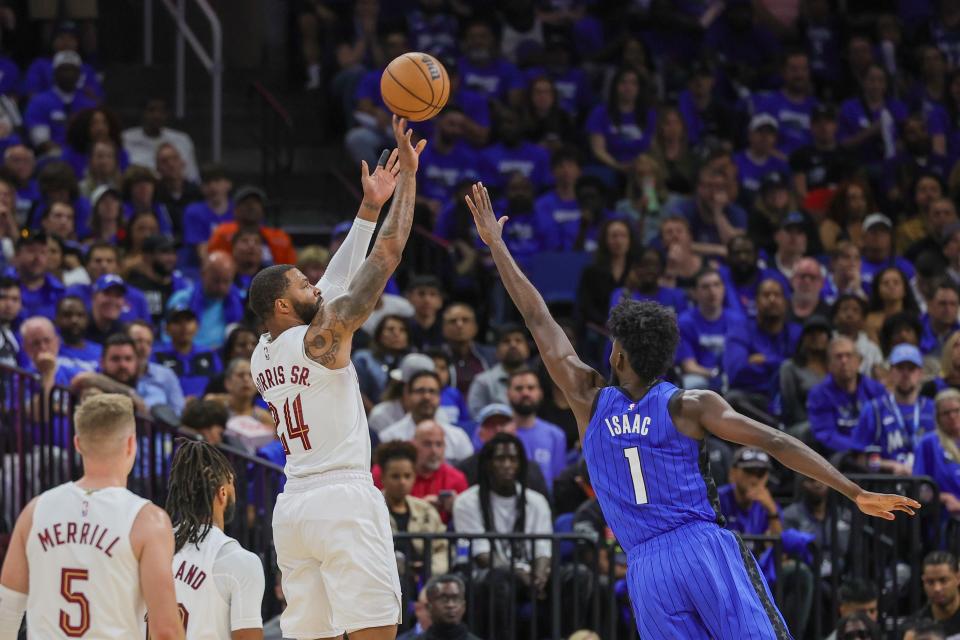 Cavaliers forward Marcus Morris Sr. shoots a 3-pointer over Magic forward Jonathan Isaac during the second half of Game 3 of the first-round playoff series, April 25, 2024, in Orlando.