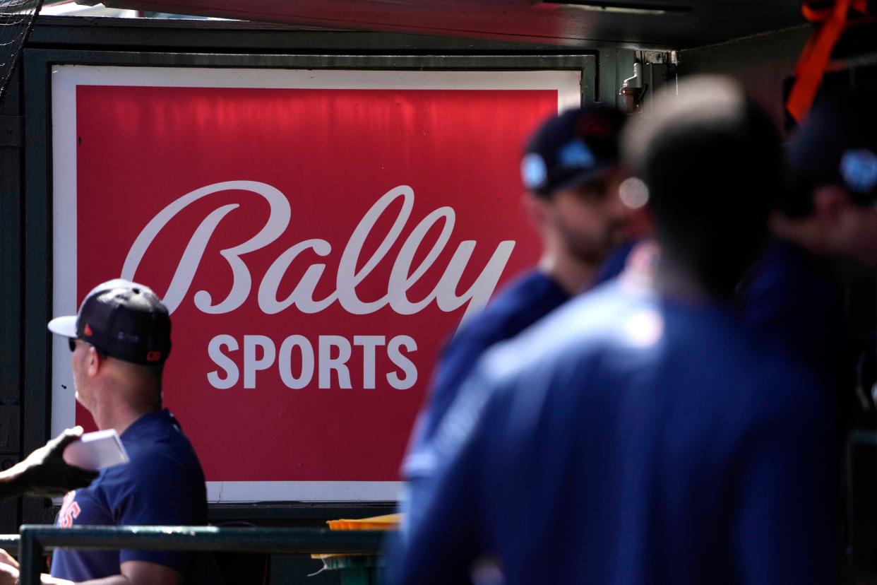 A Bally Sports sign hangs in a dugout before the start of a spring training baseball game between the St. Louis Cardinals and Houston Astros on March 2, 2023, in Jupiter, Fla.