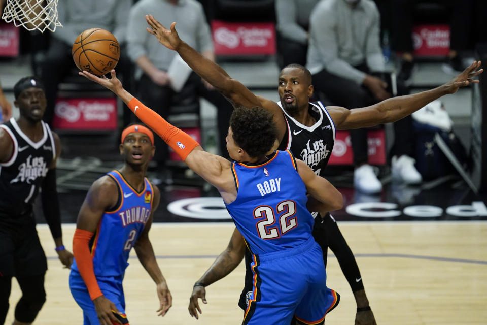 Oklahoma City Thunder forward Isaiah Roby (22) takes a shot against center Serge Ibaka, right, during the third quarter of an NBA basketball game Sunday, Jan. 24, 2021, in Los Angeles. (AP Photo/Ashley Landis)