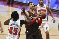 Portland Trail Blazers center Enes Kanter drives to the basket on Detroit Pistons forward Sekou Doumbouya, left, during the second half of an NBA basketball game in Portland, Ore., Saturday, April 10, 2021. The Blazers won 118-103. (AP Photo/Steve Dykes)
