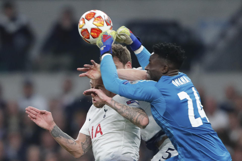 Tottenham's Toby Alderweireld, left, and Tottenham's Jan Vertonghen, center rear, and Ajax goalkeeper Andre Onana jump for the ball during the Champions League semifinal first leg soccer match between Tottenham Hotspur and Ajax at the Tottenham Hotspur stadium in London, Tuesday, April 30, 2019. (AP Photo/Frank Augstein)