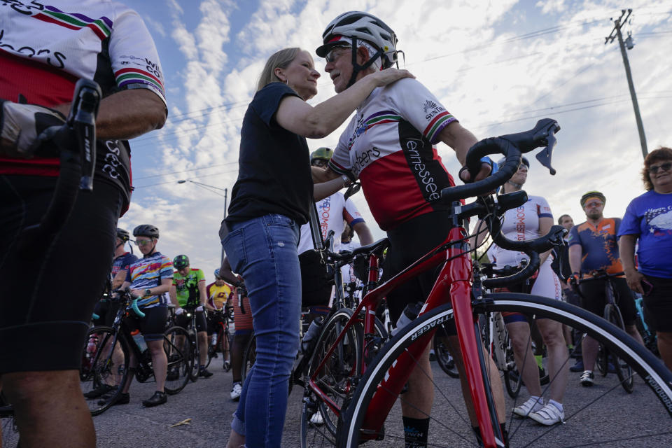 Kim Milligan, left, hugs cyclist David Burka before a memorial ride in honor of her daughter, Alyssa, Tuesday, Sept. 12, 2023, in Mount Juliet, Tenn. Milligan's daughter was struck and killed by a pickup truck while cycling with a friend the previous week. (AP Photo/George Walker IV)