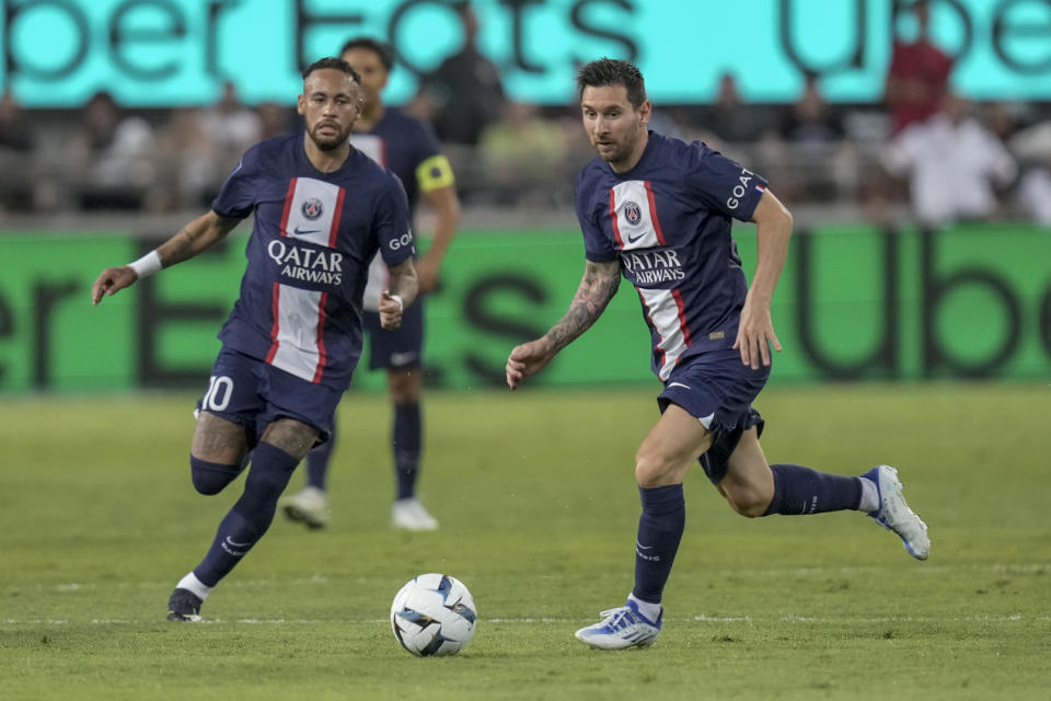 PSG's Lionel Messi, right, controls the ball as PSG's Neymar runs during the French Super Cup final soccer match between Nantes and Paris Saint-Germain at Bloomfield Stadium in Tel Aviv, Israel, Sunday, July 31, 2022. (AP Photo/Ariel Schalit)
