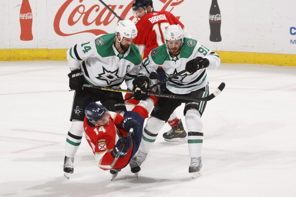 Dallas Stars center Tyler Seguin (91) and left-wing Jamie Benn (14) check Florida Panthers left wing Grigori Denisenko (14) during the third period of an NHL hockey game, Monday, May 3, 2021, in Sunrise, Fla. (AP Photo/Joel Auerbach)