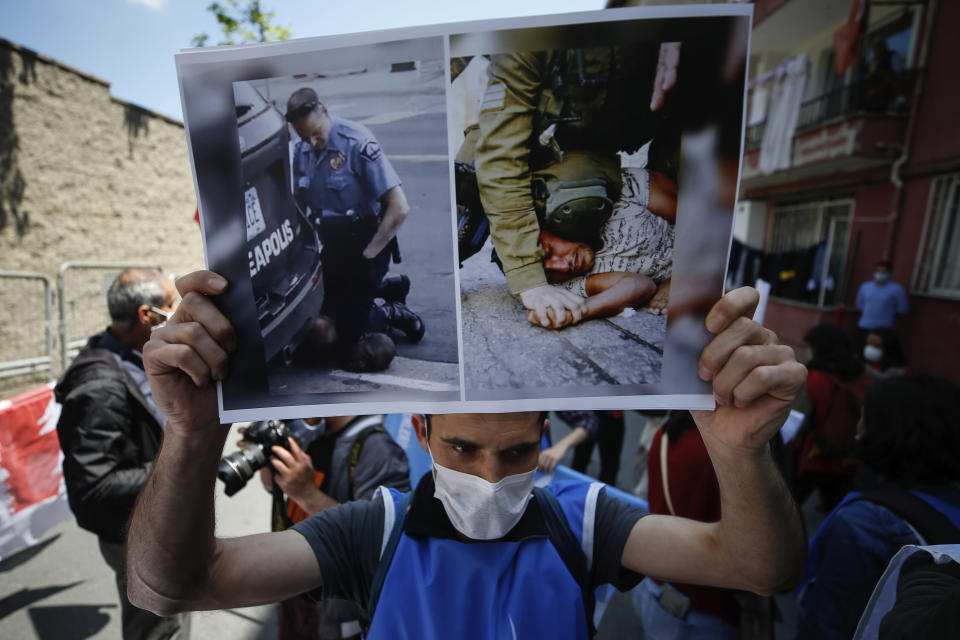 FILE - A demonstrator holds a placard with photos of George Floyd, left, a black man who died after being restrained by Minneapolis police officers on May 25, 2020 and an undated photo, right, of an Israeli soldier restraining a Palestinian youth, during a protest near the U.S. consulate in Istanbul, Thursday, June 4, 2020. A growing number of Black Americans see the struggle of Palestinians reflected in their own fights for freedom and civil rights. In recent years, the rise of protest movements in the U.S. against police brutality in the U.S., where structural racism plagues nearly every facet of life, has connected Black and Palestinian activists under a common cause. But that kinship sometimes strains the alliance between Black and Jewish activists, which extends back several decades. (AP Photo/Emrah Gurel, File)