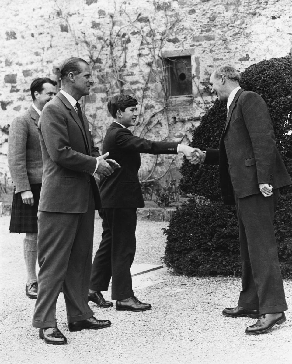 Prince Charles shakes hands with Robert Chew the headmaster of Gordonstoun School on his first day as a pupil there, 1st May 1962. He is accompanied by his father, the Duke of Edinburgh, who also attended the school.  Location: Near Elgin, Grampian, Scotland, UK. (Photo by Hulton-Deutsch/Hulton-Deutsch Collection/Corbis via Getty Images)