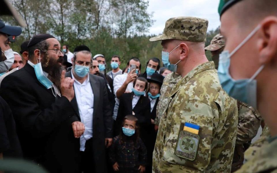 Ukraine's border service head Serhiy Deineko speaks with Jewish pilgrims, who plan to enter Ukraine from the territory of Belarus - State Border Guard Service of Ukraine/Reuters