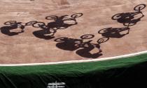 <p>Cyclists cast shadows as they compete in the men’s BMX cycling semifinal during the 2016 Summer Olympics in Rio de Janeiro, Brazil, Friday, Aug. 19, 2016. (AP Photo/Pavel Golovkin) </p>