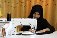 An Afghan woman tailor works with a sewing machine in the Afghan Women Business Hub in Kabul, Afghanistan, Tuesday, July 2, 2024. Half of Afghanistan's population now finds itself locked out of the freedom to work at a time when the country's economy is worse than ever, with few jobs available to women in the country. (AP Photo/Siddiqullah Alizai)