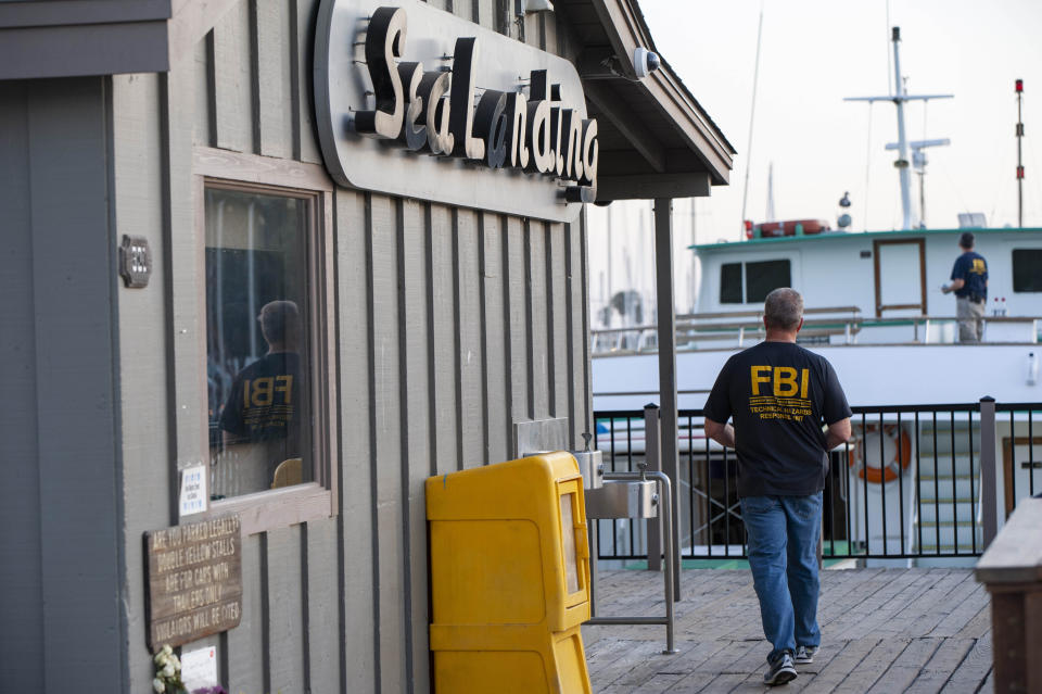 FBI investigators climb aboard the "Vision" a sister vessel to the scuba boat Conception to document its layout and learn more about the deadly pre-dawn fire that destroyed the boat in Santa Barbara, Calif., on Tuesday, Sept. 3, 2019. A fire raged through the boat carrying recreational scuba divers anchored near an island off the Southern California Coast Monday, leaving multiple people dead. Authorities ended the search for survivors Tuesday. (AP Photo/Christian Monterrosa)