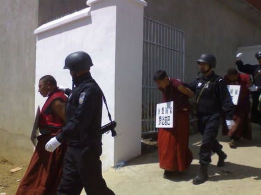 File photo shows Chinese paramilitary police leading monks wearing placards showing their names and the alleged crimes committed in a Tibetan area of southwest China's Sichuan province. Last year many people -- from renowned artist Ai Weiwei to rights lawyers and petitioners -- were illegally held in locations away from formal detention areas, sometimes for months