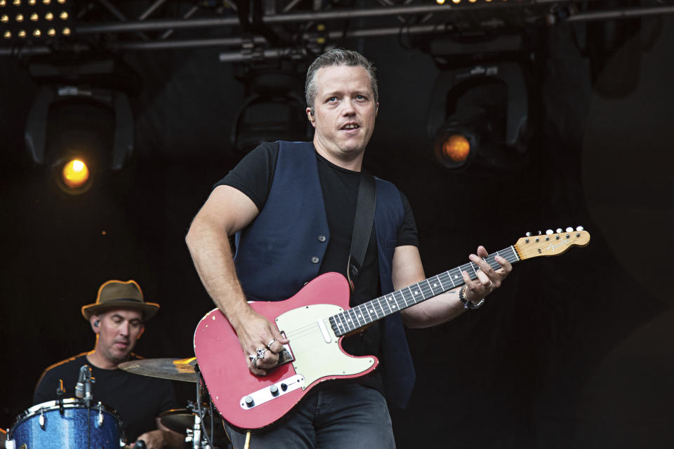 FILE - This July 15, 2018 file photo shows Jason Isbell, of Jason Isbell & The 400 Unit, performing at Forecastle Music Festival in Louisville, Ky. Isbell is king of the Americana genre, but he's ambitious for more. The new “Reunions” album reaches out sonically to people who might not normally listen to that type of music, but Isbell's well-crafted songs lie at the center of what he does. (Photo by Amy Harris/Invision/AP, File)