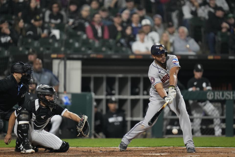 Houston Astros' Jose Abreu, right, connects with the ball but grounds out during the fourth inning of a baseball game against the Chicago White Sox, Friday, May 12, 2023, in Chicago. (AP Photo/Erin Hooley)