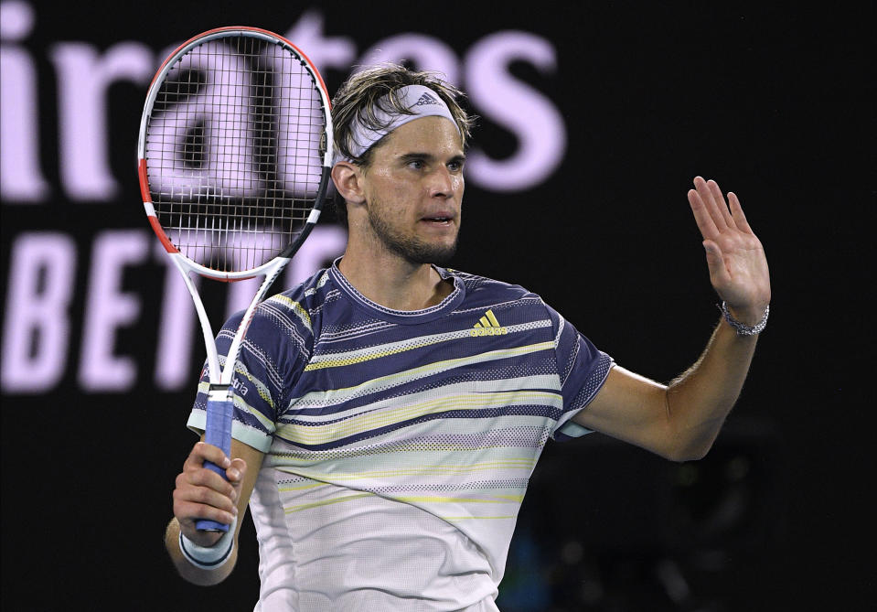 Austria's Dominic Thiem gestures to his opponent Spain's Rafael Nadal after hitting the net cord and winning the point during their quarterfinal match at the Australian Open tennis championship in Melbourne, Australia, Wednesday, Jan. 29, 2020. (AP Photo/Andy Brownbill)