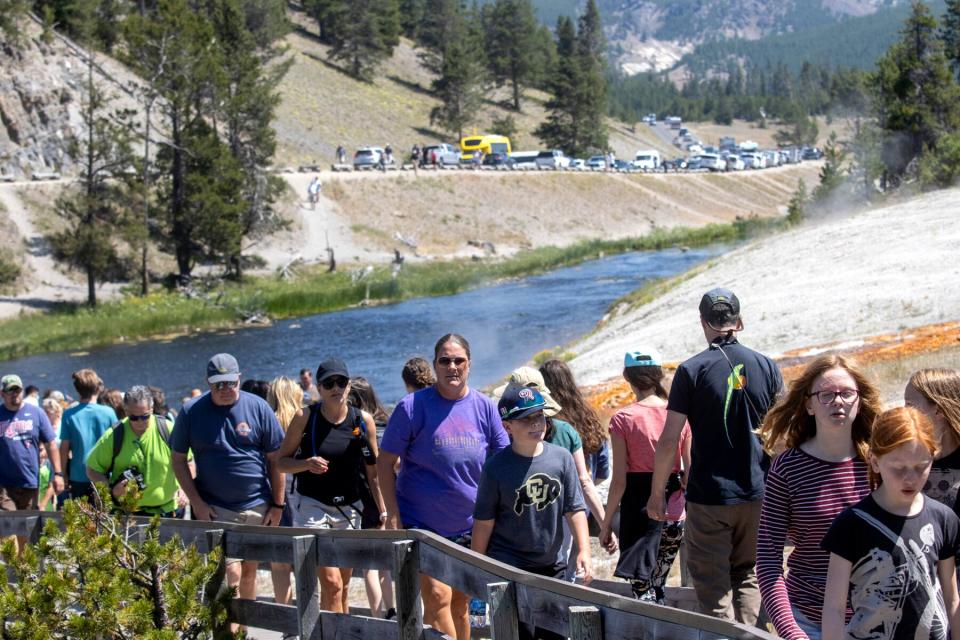 Tourists crowd in to the Midway Geyser Basin July 14, 2021 at Yellowstone National Park, Wyoming.